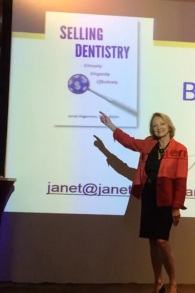Janet giving presentation at one of her speaking events.